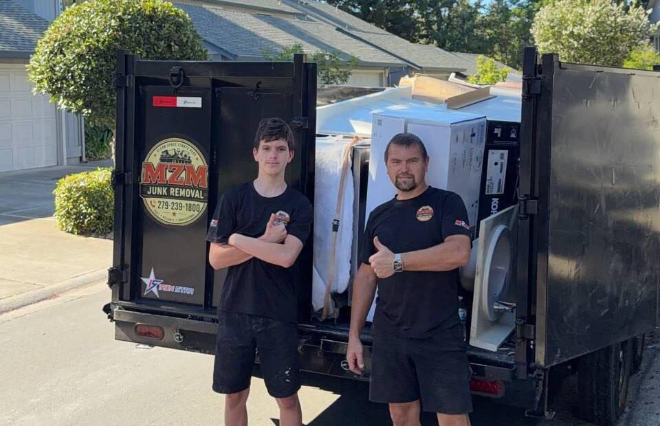Slava and Zakhar, the father-and-son MZM Junk Removal crew, at their truck in Roseville, CA
